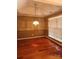Dining room with hardwood floors, a modern chandelier and a window with natural light at 14343 Arbor Ridge Dr, Charlotte, NC 28273
