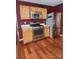Modern kitchen with stainless steel appliances, light oak cabinets, and hardwood floors at 14343 Arbor Ridge Dr, Charlotte, NC 28273