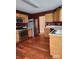 Modern kitchen with stainless steel appliances, light oak cabinets, and hardwood floors at 14343 Arbor Ridge Dr, Charlotte, NC 28273