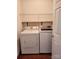 Laundry room with washer, dryer, shelving and hardwood floors at 14343 Arbor Ridge Dr, Charlotte, NC 28273