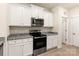 Modern kitchen with white cabinets, stainless steel appliances, and granite countertops, creating a stylish cooking space at 1528 Doran Ter, Richburg, SC 29729
