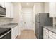 Kitchen with white cabinets, granite countertops, and stainless steel appliances, with access to doorways and hallways at 1528 Doran Ter, Richburg, SC 29729