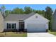 Charming single-Gathering home with white siding, a two-car garage, and a well-manicured front lawn at 1532 Doran Ter, Richburg, SC 29729
