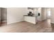Open-concept living room with luxury vinyl plank flooring and a view of the kitchen featuring granite countertops at 1532 Doran Ter, Richburg, SC 29729