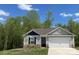 Charming single-Gathering home with stone accents, attached two-car garage, and a well-manicured lawn at 1538 Doran Ter, Richburg, SC 29729
