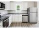 Bright kitchen featuring stainless steel appliances, granite countertops, and white cabinets at 1538 Doran Ter, Richburg, SC 29729
