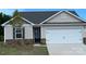 Charming single-Gathering home featuring stone accents, a white garage door, and a well-manicured front yard at 1554 Doran Ter, Richburg, SC 29729