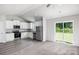 Open-concept kitchen with stainless steel appliances and dining area featuring sliding door to backyard at 1554 Doran Ter, Richburg, SC 29729