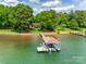 Stunning waterfront home with a private boat dock and lush green surroundings providing a serene lakeside living experience at 16317 Terry Ln, Huntersville, NC 28078