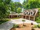 Stunning aerial view of a large home, multiple garages, and circular driveway surrounded by lush greenery at 16317 Terry Ln, Huntersville, NC 28078