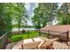 An outdoor deck boasts a view of the lake, landscaping, and outdoor seating at 16317 Terry Ln, Huntersville, NC 28078
