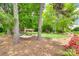Relaxing backyard featuring a hammock between mature trees, a lush lawn, and a beautiful garden at 16317 Terry Ln, Huntersville, NC 28078