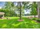 Expansive backyard featuring lush green lawn and beautiful landscaping, leading to a serene lake view at 16317 Terry Ln, Huntersville, NC 28078