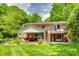 Expansive backyard featuring a well-manicured lawn, patio, and lush landscaping at 16317 Terry Ln, Huntersville, NC 28078