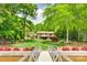 Stunning backyard view showcasing a well-manicured lawn, lush landscaping, and a dock at 16317 Terry Ln, Huntersville, NC 28078