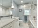 Bathroom with marble tiling, shower-tub combo, bright lighting, and vanity at 16317 Terry Ln, Huntersville, NC 28078