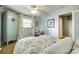 Bright bedroom with patterned bedspread, ceiling fan, and views of the outdoors through a bright window at 16317 Terry Ln, Huntersville, NC 28078