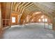 Unfinished bonus room featuring exposed wood beams, light-filled windows and open space at 16317 Terry Ln, Huntersville, NC 28078