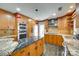 Modern kitchen featuring custom cabinetry, granite countertops, stainless steel appliances, and a breakfast bar at 16317 Terry Ln, Huntersville, NC 28078