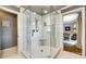 Bright, tiled shower featuring elegant hardware, seating and glass door, with views into the bedroom at 16317 Terry Ln, Huntersville, NC 28078