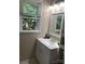 Cozy bathroom featuring a white vanity with sink, a large mirror, and a window with natural light at 1750 Sells Rd, Salisbury, NC 28144