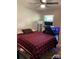 Bedroom with a red and black plaid comforter, hardwood flooring, and a well lit workspace at 1750 Sells Rd, Salisbury, NC 28144