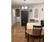 Cozy dining area with wooden table and chairs, adjacent to the laundry and a brick accent wall at 1750 Sells Rd, Salisbury, NC 28144