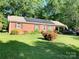 Charming home featuring a well-manicured lawn and solar panels at 1750 Sells Rd, Salisbury, NC 28144