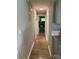A long narrow hallway with wood flooring and access to multiple rooms at 1750 Sells Rd, Salisbury, NC 28144