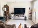 Cozy living room featuring neutral colors, soft carpet, and entertainment center, creating a relaxing atmosphere at 1750 Sells Rd, Salisbury, NC 28144