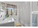 Bright bathroom with a shower, patterned tile, and neutral-toned finishes at 1792 Hoffman Rd, Gastonia, NC 28054