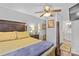 This primary bedroom features a ceiling fan, ensuite bathroom, and neutral walls at 1792 Hoffman Rd, Gastonia, NC 28054