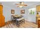 Cozy dining room with wood-look floors, modern ceiling fan, and natural light from the window at 1792 Hoffman Rd, Gastonia, NC 28054