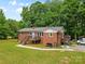 Well-kept brick home with a metal roof, multiple decks, and a spacious green lawn at 1792 Hoffman Rd, Gastonia, NC 28054