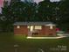 Charming brick home featuring a metal roof, inviting front porch and well-manicured lawn, perfect for peaceful living at 1792 Hoffman Rd, Gastonia, NC 28054