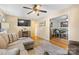 Comfortable living room featuring hardwood floors, a sectional sofa, and seamless dining access at 1792 Hoffman Rd, Gastonia, NC 28054