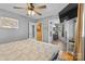 Serene main bedroom with a ceiling fan, ensuite bath, and wood-look flooring at 1792 Hoffman Rd, Gastonia, NC 28054