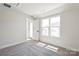 Sun-drenched bedroom featuring soft gray carpet, white trim and access to private outdoor space at 2013 Clarksdale Dr # 38, Charlotte, NC 28206
