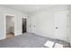 Bright bedroom with neutral carpet featuring multiple doors for closet and bathroom access at 2013 Clarksdale Dr # 38, Charlotte, NC 28206