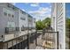 View from balcony showcasing multi-level townhomes with black railings, garages, and landscaped grounds at 2013 Clarksdale Dr # 38, Charlotte, NC 28206