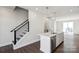 A modern kitchen island is shown with white cabinets, stainless steel appliances, and hanging lights at 2013 Clarksdale Dr # 38, Charlotte, NC 28206