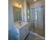 Bathroom boasts quartz countertops, glass shower, and tile at 2013 Clarksdale Dr # 38, Charlotte, NC 28206