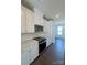 Modern kitchen features white cabinets, stainless steel appliances, quartz countertops, and subway tile backsplash at 2013 Clarksdale Dr # 38, Charlotte, NC 28206