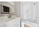 Bathroom featuring a vanity with storage, a tub with white tiling, and plenty of natural light at 213 Benfield Rd, Kings Mountain, NC 28086
