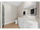 A modern half-bathroom featuring a vanity with generous storage and a decorative mirror at 213 Benfield Rd, Kings Mountain, NC 28086