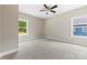 A serene bedroom with carpet, natural light from two windows, and a ceiling fan at 213 Benfield Rd, Kings Mountain, NC 28086