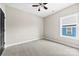 Carpeted bedroom filled with natural light from a large window and a ceiling fan at 213 Benfield Rd, Kings Mountain, NC 28086
