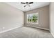 Carpeted bedroom with a view of the outdoors through a large window, lit by a ceiling fan at 213 Benfield Rd, Kings Mountain, NC 28086