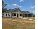 Two new homes boast inviting covered front porches, fresh landscaping, and contrasting white and blue exteriors at 213 Benfield Rd, Kings Mountain, NC 28086