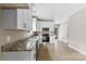 Modern kitchen with granite counters, stainless steel appliances, and white cabinets, connecting to the living area at 213 Benfield Rd, Kings Mountain, NC 28086